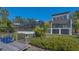 Beautiful backyard featuring a screened-in pool, lovely landscaping, and a private dock with adirondack chairs at 3151 Bayou Sound, Longboat Key, FL 34228