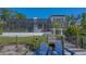Dockside view of home exterior from dock with seating and screened-in lanai at 3151 Bayou Sound, Longboat Key, FL 34228