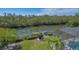 Aerial view of backyard and dock overlooking lush greenery with boat access at 3151 Bayou Sound, Longboat Key, FL 34228