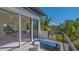 Balcony view of the bedroom, a partial view of the pool, and the surrounding trees at 3151 Bayou Sound, Longboat Key, FL 34228