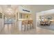 Stylish wet bar area with a granite countertop and seating, open to the dining and kitchen areas at 3151 Bayou Sound, Longboat Key, FL 34228