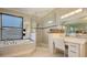 Bright bathroom features walk in shower, soaking tub, large vanity and lots of natural light at 3151 Bayou Sound, Longboat Key, FL 34228