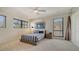 Bedroom with natural light, ceiling fan, windows, closet and striped bed at 3151 Bayou Sound, Longboat Key, FL 34228