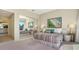 Bright bedroom featuring mirrored closet doors, a queen bed and soft natural light at 3151 Bayou Sound, Longboat Key, FL 34228