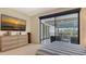 Bedroom with balcony, offering outdoor views and an entertainment console with a sunset picture at 3151 Bayou Sound, Longboat Key, FL 34228
