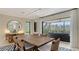 Bright dining room boasts a large wooden table, stylish chairs, and a serene view of the screened lanai at 3151 Bayou Sound, Longboat Key, FL 34228