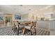 Open dining area features a wooden table, stylish rug and is adjacent to the kitchen, great for Gathering meals at 3151 Bayou Sound, Longboat Key, FL 34228