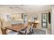 Dining room with wooden table, stylish chairs, and adjacent kitchen area, perfect for casual dining at 3151 Bayou Sound, Longboat Key, FL 34228