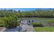 Waterfront dock with chairs overlooking tranquil canal waters surrounded by lush greenery at 3151 Bayou Sound, Longboat Key, FL 34228