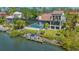 Back of house boasts a screened-in pool, second-story balcony and a private dock on the water at 3151 Bayou Sound, Longboat Key, FL 34228