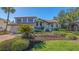 Well-maintained home exterior with a tile roof, manicured landscaping, and an attached two-car garage at 3151 Bayou Sound, Longboat Key, FL 34228
