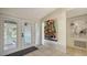 Inviting foyer with bright tile flooring, decorative artwork, and a glass front door, creating an elegant entrance at 3151 Bayou Sound, Longboat Key, FL 34228