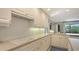 Well-lit kitchen featuring countertops, white cabinets and modern appliances for seamless food preperation at 3151 Bayou Sound, Longboat Key, FL 34228