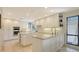 Bright kitchen features an island, white cabinets, and stainless appliances, ideal for any home chef at 3151 Bayou Sound, Longboat Key, FL 34228