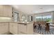 Modern kitchen features white cabinets, countertops, and an adjacent dining area for a seamless culinary experience at 3151 Bayou Sound, Longboat Key, FL 34228