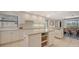 Spacious kitchen with island, white cabinets, and adjacent dining area, perfect for entertaining and cooking at 3151 Bayou Sound, Longboat Key, FL 34228