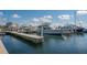 Picturesque marina view with docked yachts and sailboats under a bright sky and fluffy clouds at 3151 Bayou Sound, Longboat Key, FL 34228