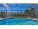 Enjoy this screened pool with serene canal views and private tropical surroundings at 3151 Bayou Sound, Longboat Key, FL 34228