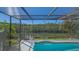 Sparkling pool in a screened enclosure with views of a serene canal and lush greenery at 3151 Bayou Sound, Longboat Key, FL 34228