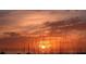 Beautiful sunset view over the ocean, with warm orange and pink hues reflected in the sky and silhouette of beach grass at 3151 Bayou Sound, Longboat Key, FL 34228