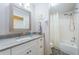 Well-lit bathroom featuring a granite countertop, tiled floors, and a shower with white tile surround at 3424 90Th N Ter, Pinellas Park, FL 33782