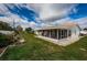 Exterior view of home featuring a sunroom addition and a lush, green lawn at 3424 90Th N Ter, Pinellas Park, FL 33782