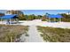 Beach access with picnic shelters, picnic tables, and sandy pathway at 3467 Byron Ln, Longboat Key, FL 34228