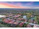 Community aerial view showcasing the neighborhood's layout, pond, and lush landscaping at 3715 80Th E Dr, Sarasota, FL 34243