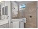Walk-in shower with glass enclosure, a window, and tile surround in the bathroom at 3715 80Th E Dr, Sarasota, FL 34243