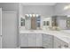 Bathroom with double sinks, quartz counters, decorative light fixture, and a glass enclosed shower at 3715 80Th E Dr, Sarasota, FL 34243