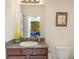 Bathroom featuring a single vanity with a granite countertop, dark wood cabinets, and a decorative vase adding a pop of color at 3715 80Th E Dr, Sarasota, FL 34243