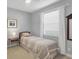 Bedroom with natural light featuring a twin bed, side table and neutral decor at 3715 80Th E Dr, Sarasota, FL 34243
