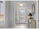 Inviting front entrance with a decorative glass door and transom window, leading into the home at 3715 80Th E Dr, Sarasota, FL 34243