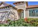 Close-up of a home's entrance, featuring a brick driveway and a beautifully landscaped front yard at 3715 80Th E Dr, Sarasota, FL 34243