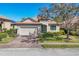 Beautiful home featuring a brick driveway, manicured lawn and well-maintained landscaping at 3715 80Th E Dr, Sarasota, FL 34243