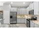 Bright kitchen with stainless steel appliances, white cabinetry, mosaic backsplash, and a gas range at 3715 80Th E Dr, Sarasota, FL 34243
