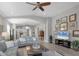 Open concept living room featuring wood floors, comfortable seating, and an open layout at 3715 80Th E Dr, Sarasota, FL 34243