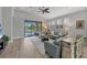 Bright living room with a ceiling fan, sliding glass doors to the lanai, and comfortable seating at 3715 80Th E Dr, Sarasota, FL 34243