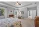 Large main bedroom with tray ceiling, large windows, and neutral decor at 3715 80Th E Dr, Sarasota, FL 34243