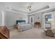 Spacious main bedroom with tray ceiling, ceiling fan, and ensuite bathroom at 3715 80Th E Dr, Sarasota, FL 34243