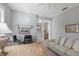 Home office with a large desk, computer, sofa, and view into an open hallway at 3715 80Th E Dr, Sarasota, FL 34243