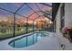 Screened-in pool provides a private oasis with a relaxing view of the serene pond at 3715 80Th E Dr, Sarasota, FL 34243