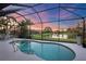 Screened-in pool provides a private oasis with a relaxing view of the serene pond at 3715 80Th E Dr, Sarasota, FL 34243