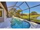 Inviting pool with screened enclosure, offering a private outdoor space for relaxation and entertainment at 3715 80Th E Dr, Sarasota, FL 34243