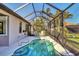 Refreshing pool with a screened enclosure, perfect for enjoying the outdoors in a private setting at 3715 80Th E Dr, Sarasota, FL 34243