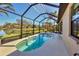 Inviting screened-in pool area overlooking a serene backyard with lush greenery and a tranquil pond view at 3715 80Th E Dr, Sarasota, FL 34243
