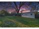 Spacious backyard with green lawn and a storage shed, surrounded by mature trees at 4015 11Th W Ave, Bradenton, FL 34205