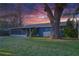 View of home's rear exterior, featuring an enclosed back porch and spacious lawn at 4015 11Th W Ave, Bradenton, FL 34205