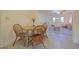 Bright dining area features a table with seating for four and an open view of the living room at 4015 11Th W Ave, Bradenton, FL 34205