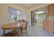 Bright dining area with wood table, open to living room and kitchen with stainless steel appliances at 4015 11Th W Ave, Bradenton, FL 34205